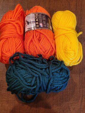 Set of 4 skeins Lion Brand Hometown yarn super bulky orange, yellow, dark teal.
